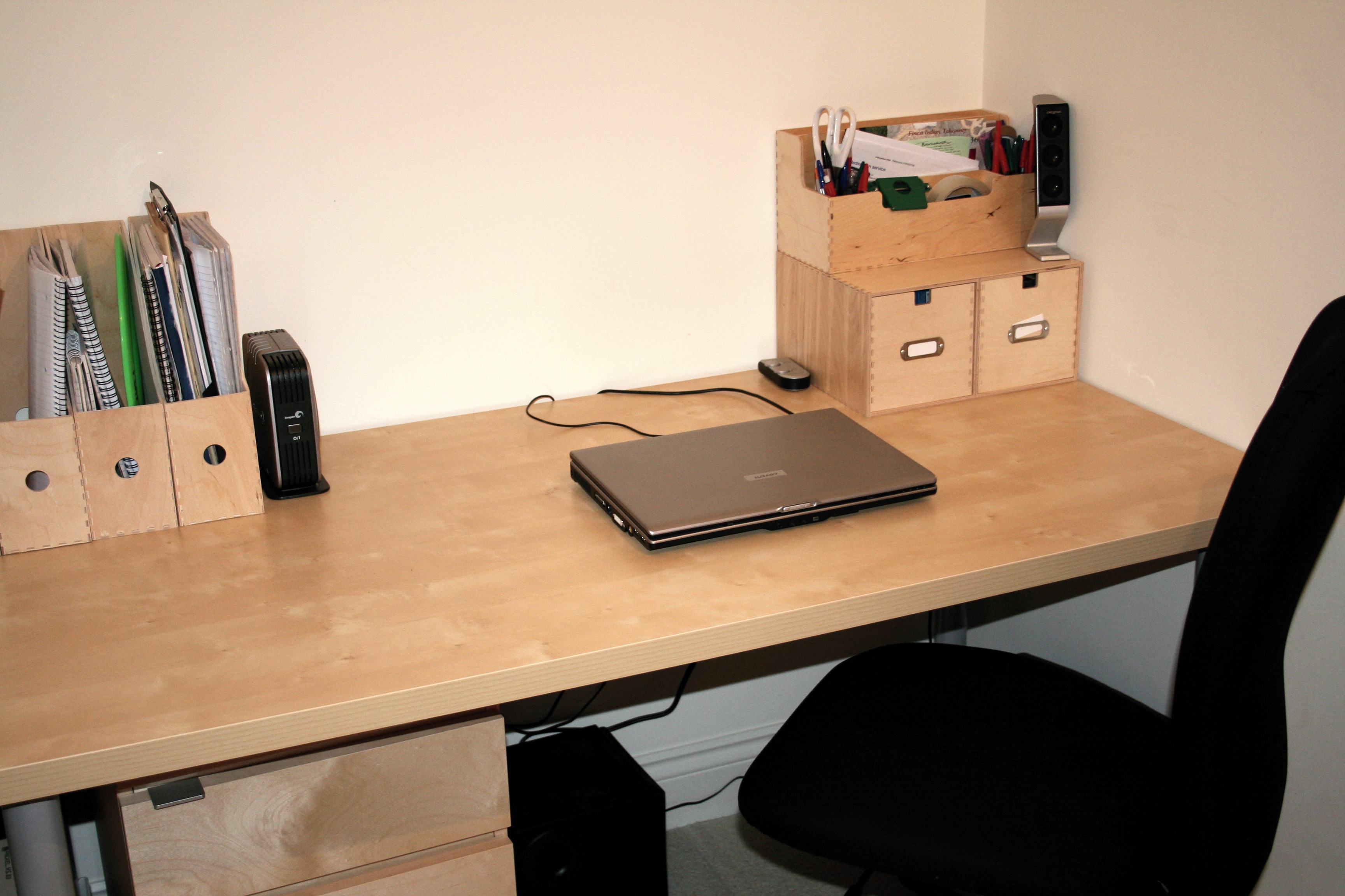 Tidy desk with laptop and speaker