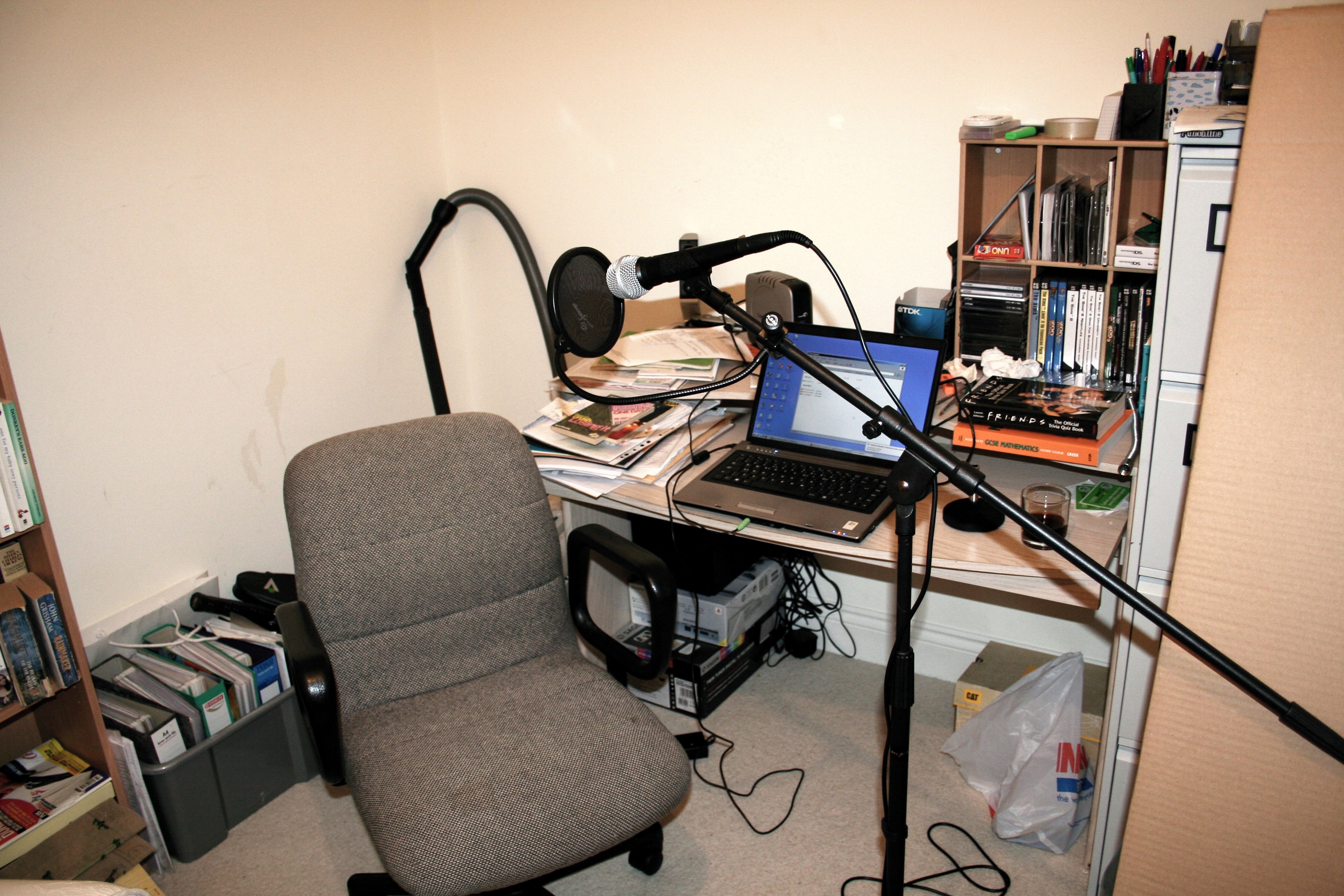 Desk and chair with laptop, books and clutter