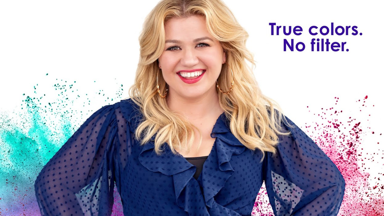 Promotional image for The Kelly Clarkson show featuring Kelly Clarkson in a purple dress, and the tag line ’true colours, no filter.’
