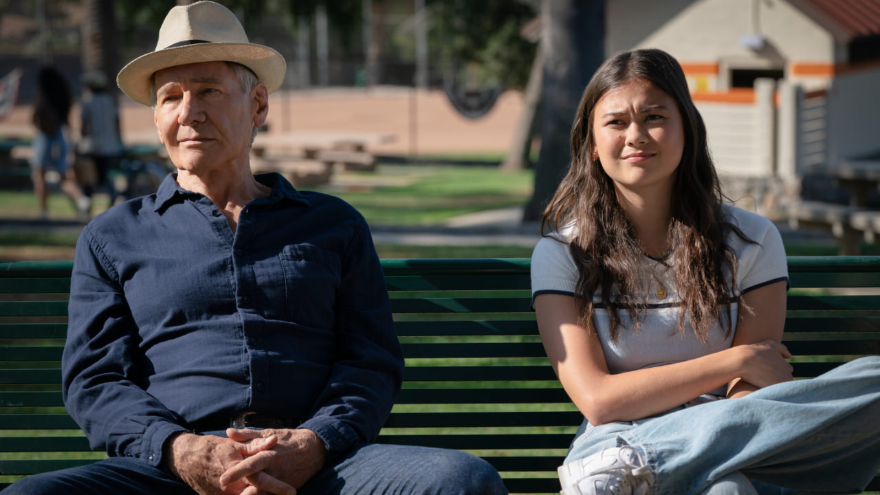 A still from the Apple TV show Shrinking showing Harrison Ford as Paul and Lukita Maxwell as Alice sitting side by side on a bench