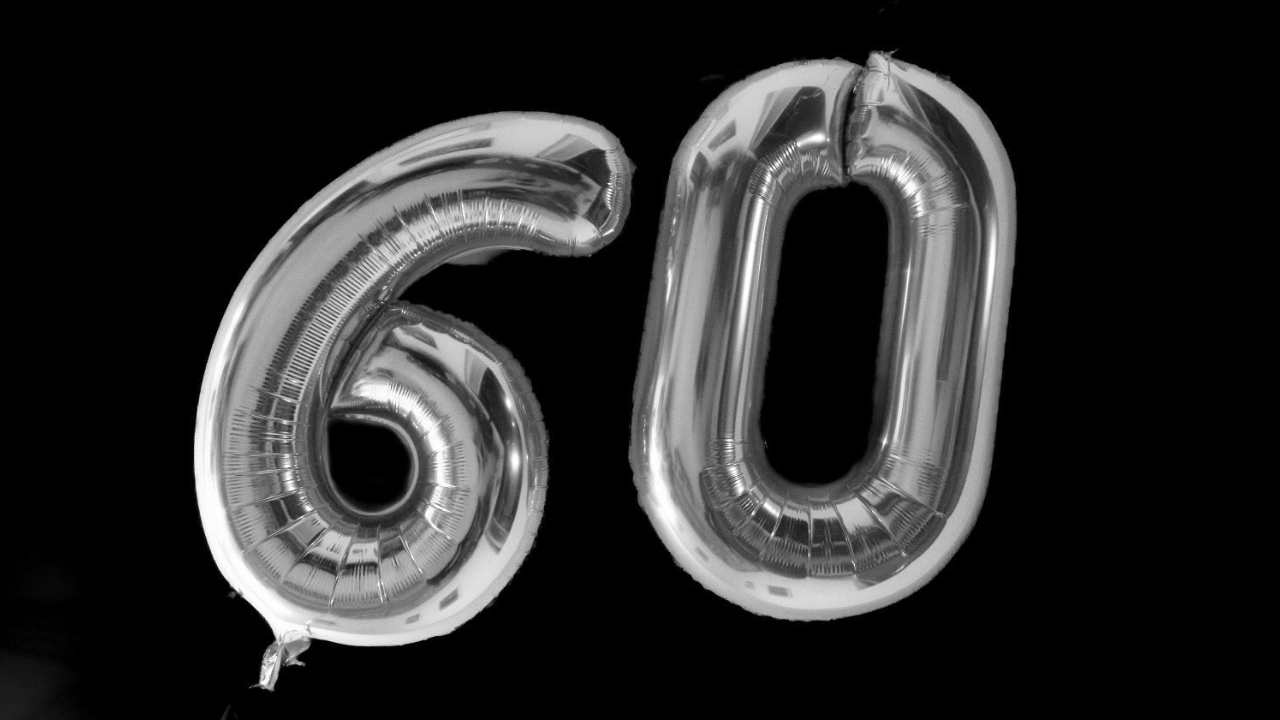 A black and white image of two balloons spelling out &lsquo;60&rsquo;