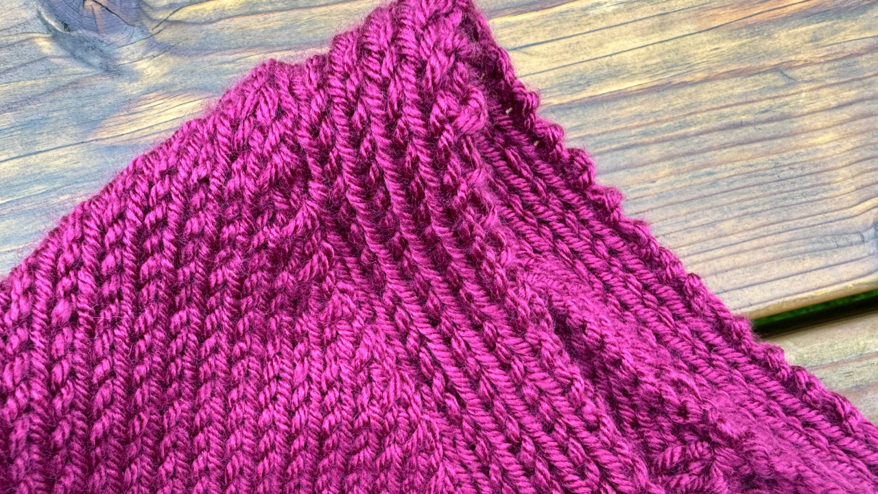 A close up of the knitted neckline showing nice neat rows of yarn