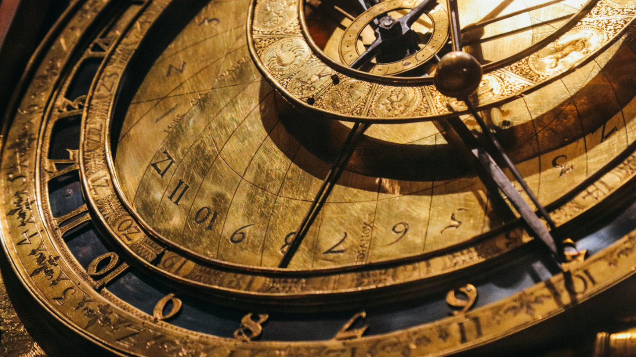 An old style steampunk clock in blue and gold with various layers and dials