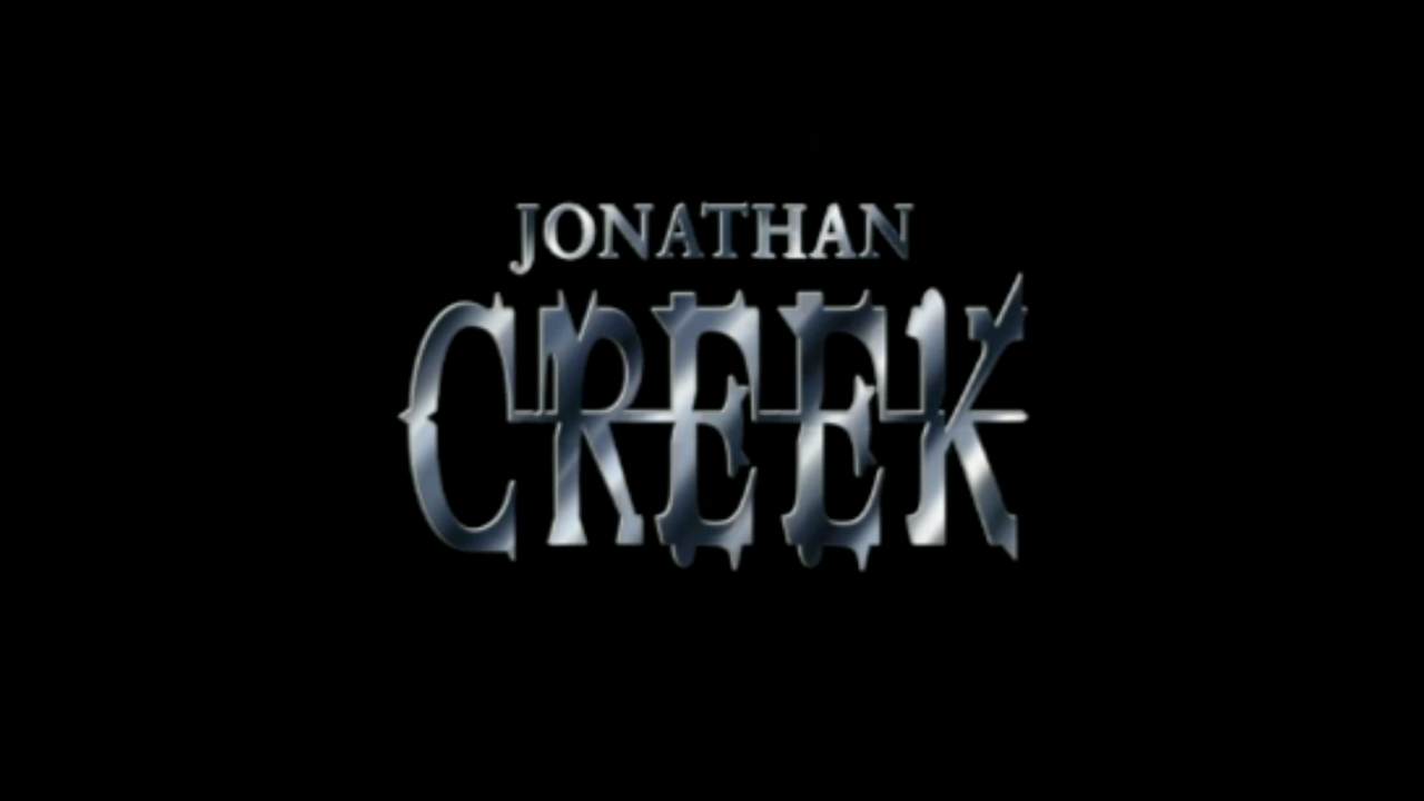 The title screen for the BBC series Jonathan Creek, a black screen with the title in embossed silver gothic style lettering