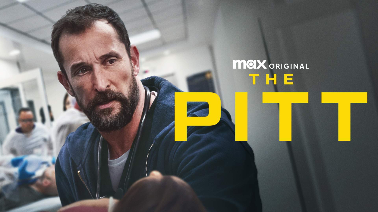A marketing photo for The Pitt, featuring Noah Wyle in character as a doctor, leaning over a gurney, with the text The Pitt to the right